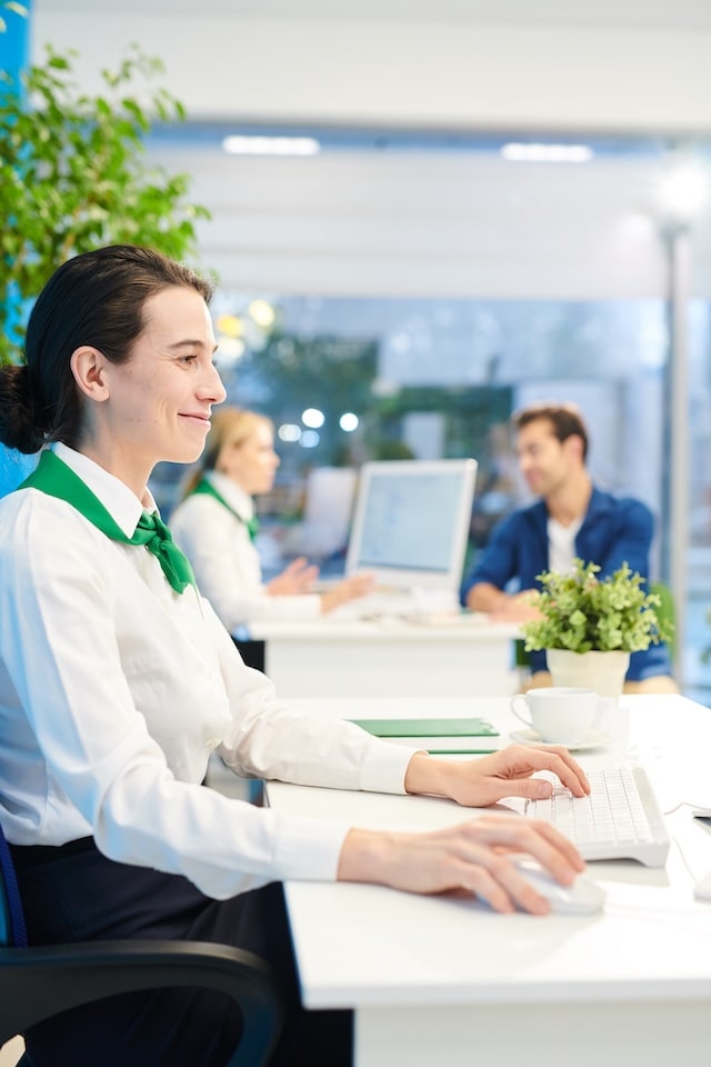 satisfied-bank-employee-using-computer-2025-03-08-02-30-13-utc-min